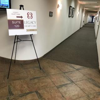 A corridor with a directional sign indicating the way to Suite 130.