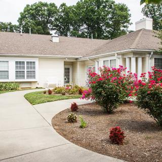 A picturesque house with a landscaped garden and a winding pathway.