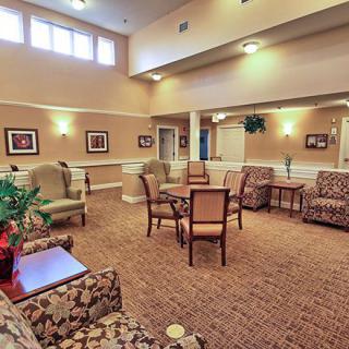 A spacious living area featuring comfortable seating, tables, and decorative elements.