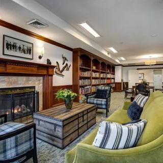 A modern living room featuring a fireplace, bookshelves, and comfortable seating.