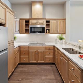 A modern kitchen with wooden cabinets and stainless steel appliances.