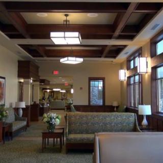 A spacious and well-lit lobby area with comfortable seating and large windows.