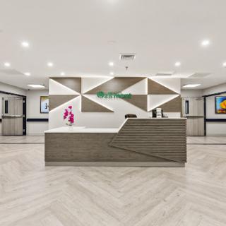 A modern hotel lobby featuring a stylish reception area with geometric design elements.