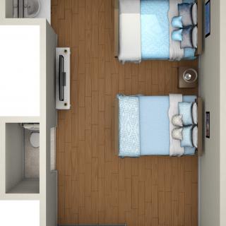 A top-down view of a bedroom with twin beds and wooden flooring.