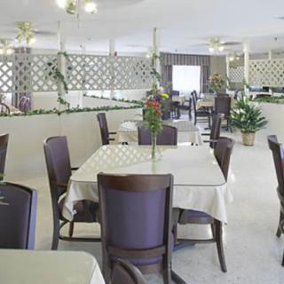 An elegant dining area with neatly arranged tables and chairs, featuring tasteful decor.