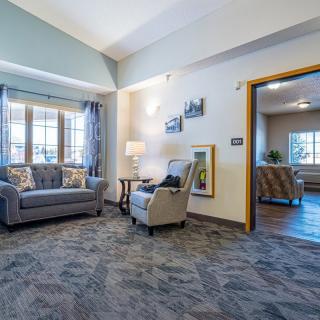 A cozy living room with comfortable seating and large windows.