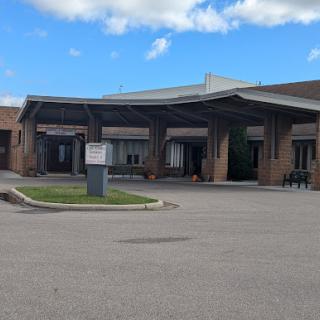 A welcoming entrance to a facility under a blue sky.