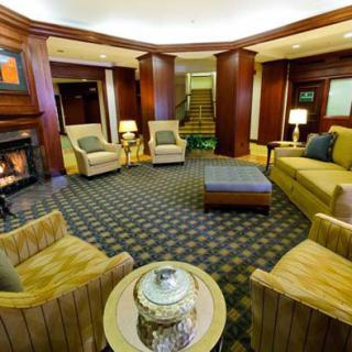A cozy hotel lobby featuring comfortable seating and a fireplace.