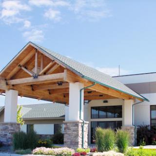 A welcoming entrance to a modern lodge with wooden architectural features.