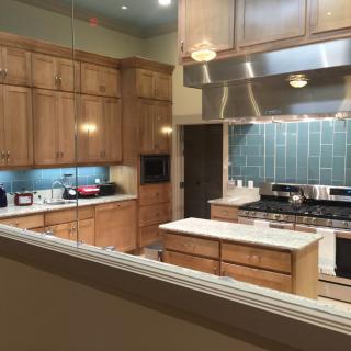 A modern kitchen with wood cabinets and stainless steel appliances.