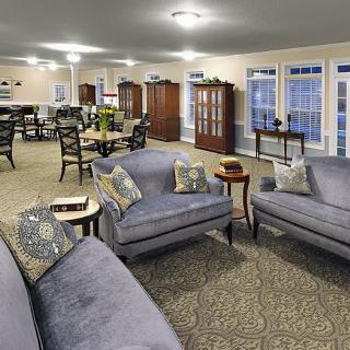 Spacious living room with comfortable sofas, a dining area, and elegant lighting.