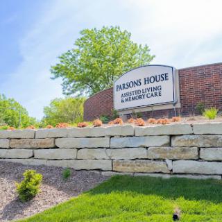 Entrance sign of Parsons House, an assisted living and memory care facility, surrounded by a well-maintained landscape.