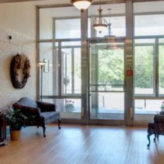 A well-lit lobby with seating and glass doors leading outside.