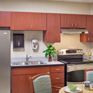 A modern kitchen with wooden cabinets and stainless steel appliances.