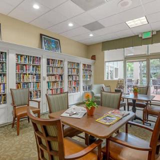 A cozy library with bookshelves and a comfortable reading area.