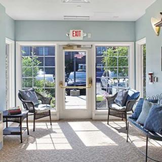 A bright waiting area with comfortable seating and large windows letting in natural light.