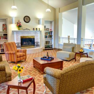 A cozy living room with a fireplace and comfortable seating.