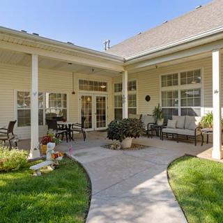 A cozy patio area with comfortable seating and a well-maintained garden.
