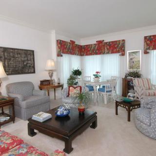 A cozy living room with comfortable seating, a central coffee table, and decorative elements creating a warm atmosphere.