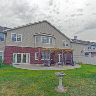 A suburban house with a backyard patio and garden area.