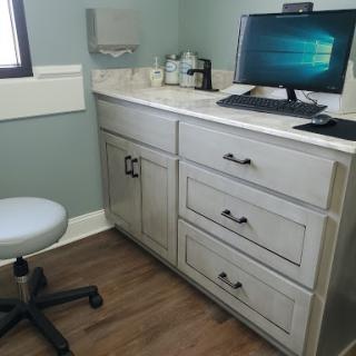 A modern office workspace featuring a desk with a computer and storage drawers.