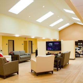 A modern and spacious living room with comfortable sofas and a large TV.