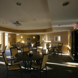 A well-lit dining area with tables and chairs arranged neatly.
