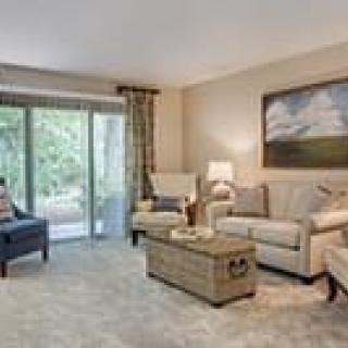 A cozy living room with comfortable seating and large windows.
