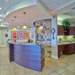 A modern reception area with stylish lighting and artwork on the walls.