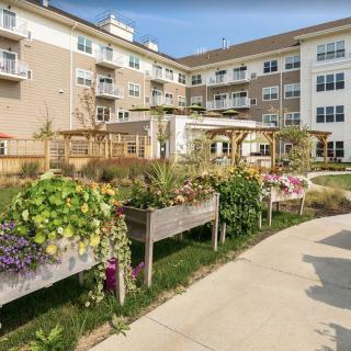 A residential building with a landscaped garden and pathway.