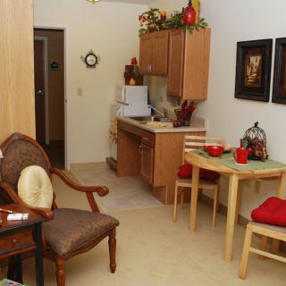 Cozy kitchen and dining area with wooden cabinets and a small table setup.