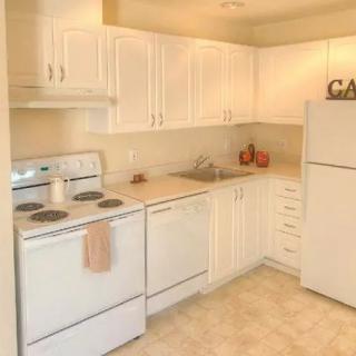 A bright kitchen with white cabinetry and modern appliances.
