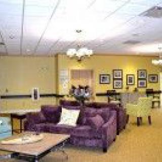 A comfortable lounge area with sofas and tables, decorated in warm tones.