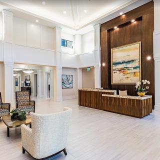 A modern lobby featuring a spacious reception area with elegant furniture and artwork.