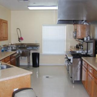A clean commercial kitchen with stainless steel appliances and ample counter space.