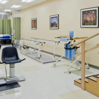 A well-equipped physical therapy clinic featuring exercise equipment and treatment areas.