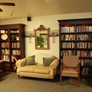 A cozy reading area with bookshelves and a comfortable sofa.