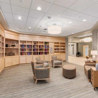 A modern library interior with comfortable seating and bookshelves.