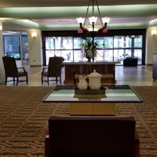 A spacious hotel lobby featuring comfortable seating and elegant decor.