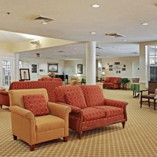 A spacious living room with comfortable sofas and chairs arranged in a cozy seating area.