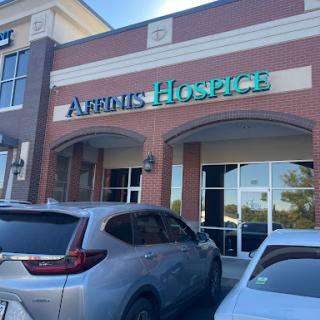 Exterior view of Aegis Hospice with cars parked in front.