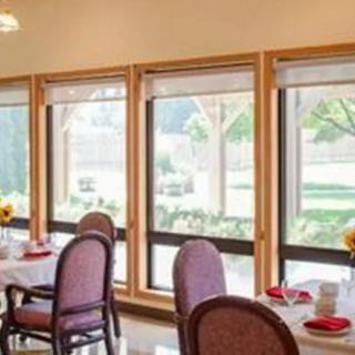 A bright and cozy dining area with large windows letting in natural light.