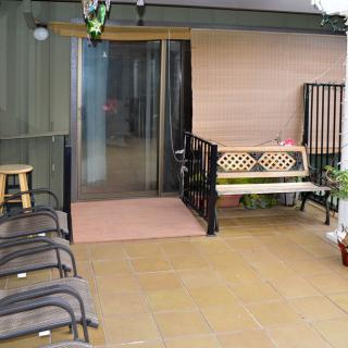 A cozy patio area with seating and plants.
