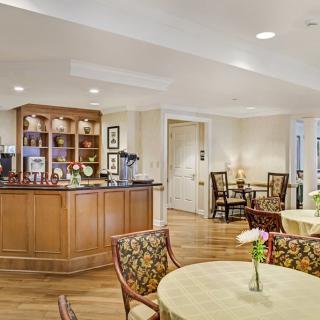 A cozy dining area with elegant furniture and a wooden bar counter.