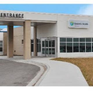 Entrance of a healthcare facility with clear signage and accessible pathways.
