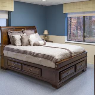 A beautifully designed wooden bed with elegant linens in a cozy bedroom setting.