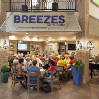 A group of people socializing at Breezes Bar & Bistro.