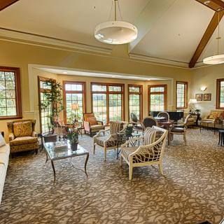 A spacious and well-lit lounge with comfortable seating arrangements.