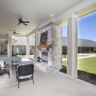 Modern outdoor patio with a cozy fireplace and comfortable seating area.
