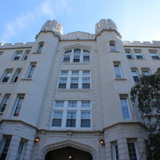 A historic building featuring castle-like architecture and decorative towers.